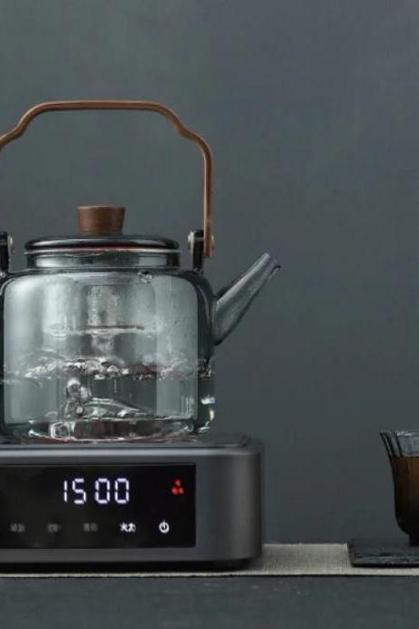 Glass Kettle With Wood Handle On Digital Induction Cooktop